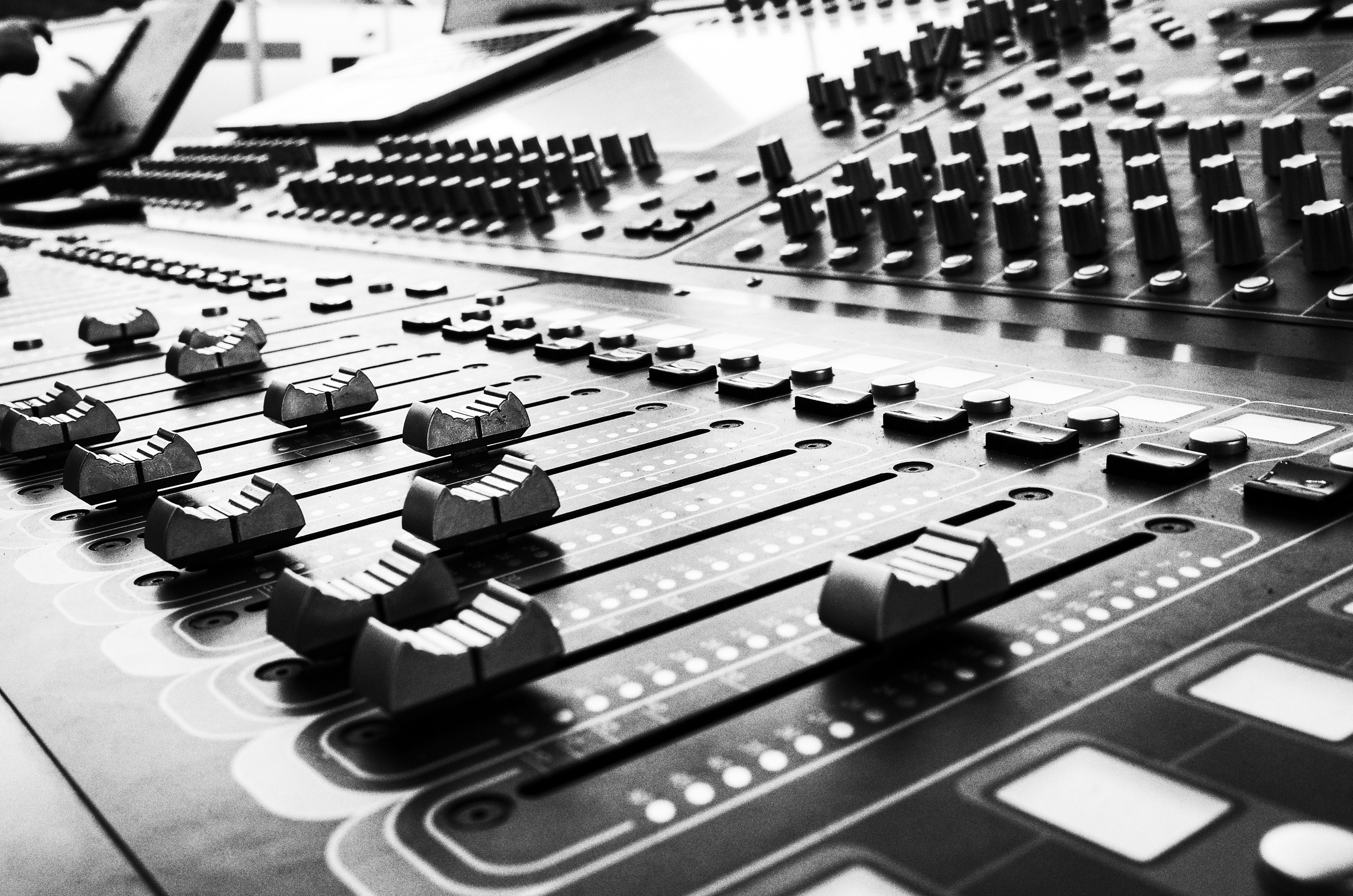 Closeup photo of an audio mixing board